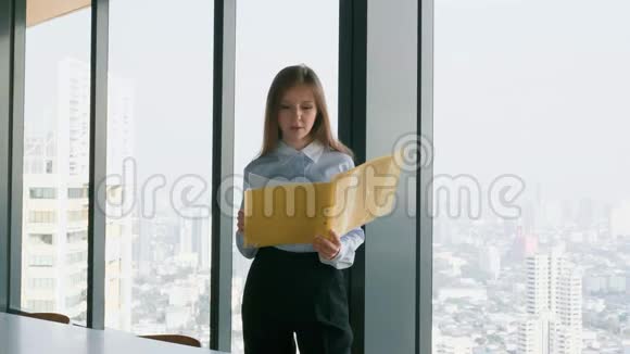 商务女性拿着文件夹窗口附近有城市景观视频的预览图