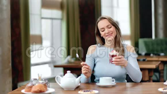 快乐的女人拿着甜点想着节食和减肥红色相机中景视频的预览图