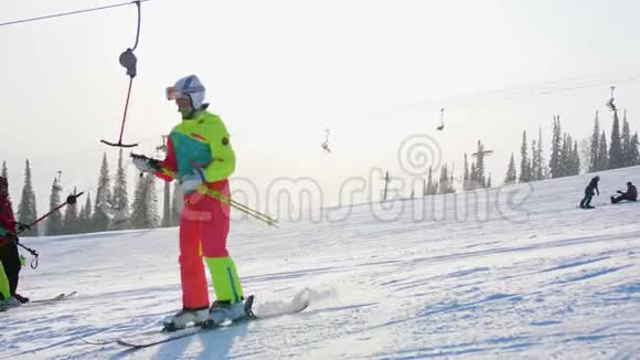 滑雪坡滑雪者和滑雪者骑在跑道上一个滑雪者用滑雪缆车爬山视频的预览图