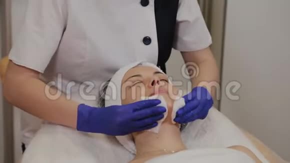 专业美容师用湿巾擦拭女人的脸视频的预览图