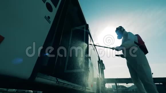 冠状病毒预防卫生消毒工艺公交车被环卫工人消毒的外景视频的预览图
