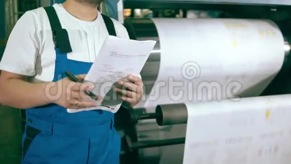 男性专家在造纸厂做笔记视频的预览图