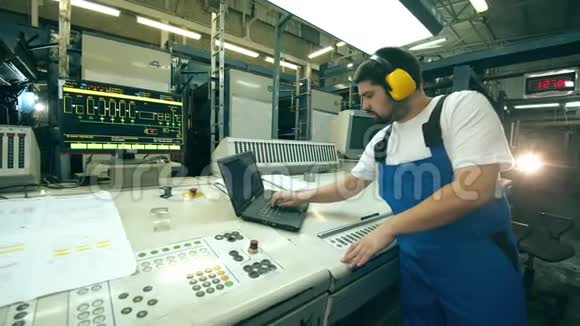电脑控制台和一名男性工厂工人操作视频的预览图