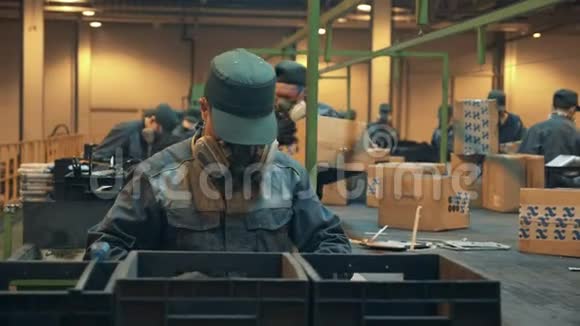 垃圾填埋场的工人正在整理箱子和有缺陷的电子产品工厂的男员工正在整理垃圾视频的预览图