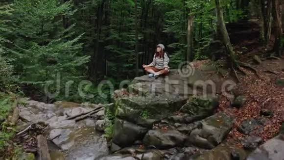 天女在山上远足在悬崖上眺望远处美丽的风景林森林冥想视频的预览图