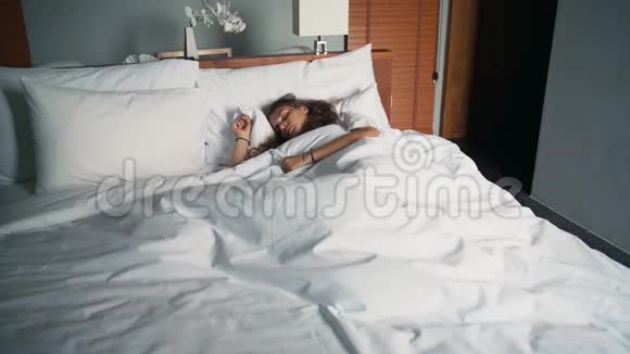 一个年轻的白种人女人睡在床上视频的预览图