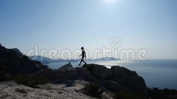 运动小女孩走在克里米亚的一座著名的山上女性欣赏美丽的海景和海景视频的预览图