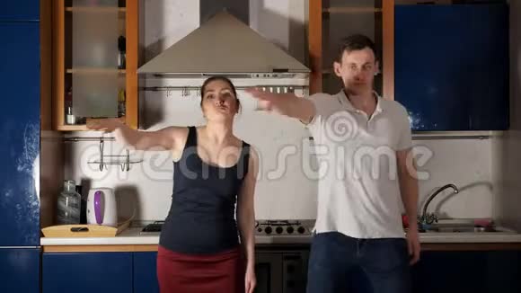 快乐的男人和女人跳舞跳起来玩厨房视频的预览图