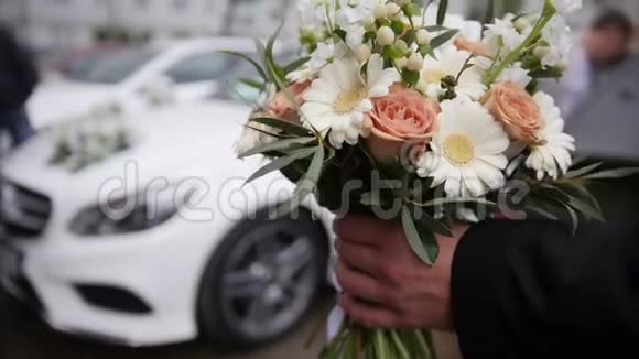 豪华轿车前的婚礼花束视频的预览图