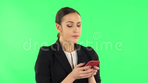 年轻女子在手机上发短信绿色屏幕视频的预览图
