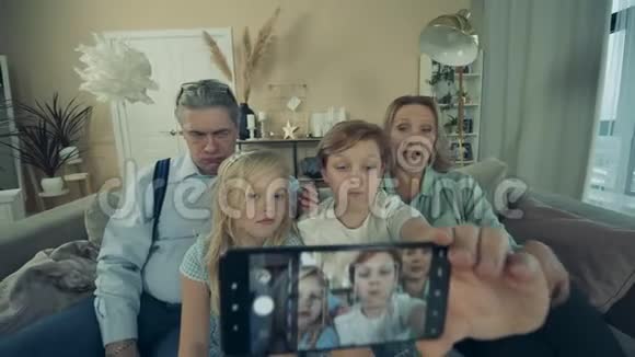小孩子和他们的祖父母正在家里自拍视频的预览图