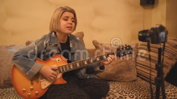 女孩去掉了学习弹吉他的vlog一名青少年正在为社交网络录制视频视频的预览图