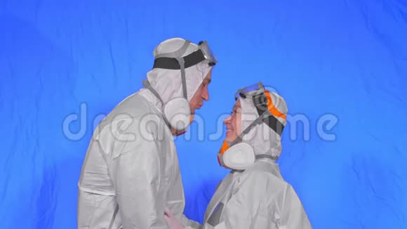 医生男女穿防护服防毒防护医用喷漆口罩爱的情侣亲吻拥抱健康视频的预览图