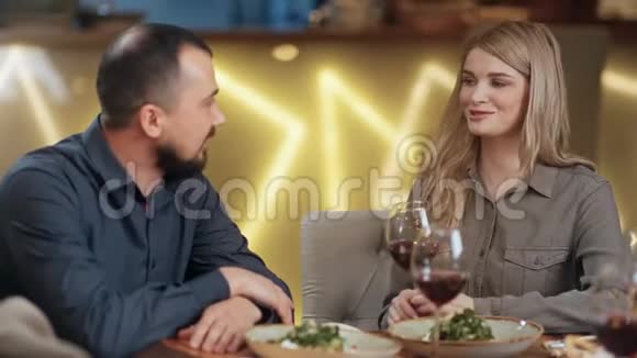 笑的女孩和男人友好的交谈在咖啡馆喝酒近距离拍摄4k红色相机视频的预览图