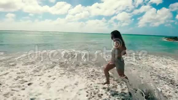 快乐的女士在低潮时沿着海岸奔跑视频的预览图