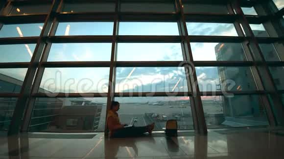 机场候机大厅和一位坐在地上的女士视频的预览图