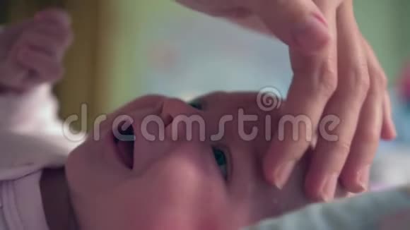 新生儿的肖像母亲用过敏乳膏或其他皮肤疾病润滑儿童脸白色视频的预览图