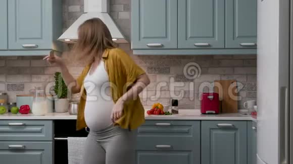 在烹饪过程中期待女性在舒适的厨房中积极跳舞视频的预览图
