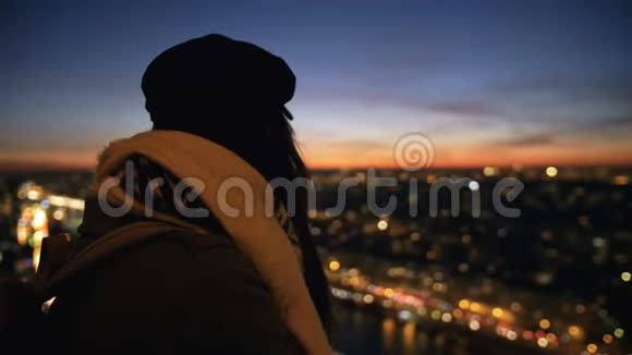 后视美丽快乐年轻旅游妇女观看不可思议的日落城市天空背景从角度慢动作视频的预览图