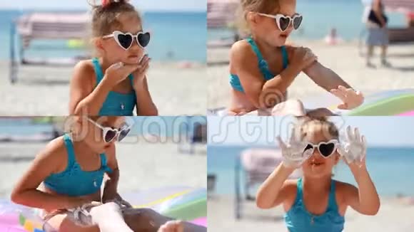 小女孩在靠近大海的身体和脸上涂抹防晒霜晒伤防晒霜防晒霜可爱的儿童视频的预览图