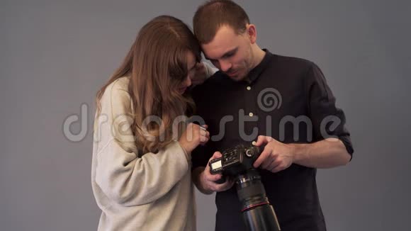 摄影师和模特正在观看拍摄的图像视频的预览图