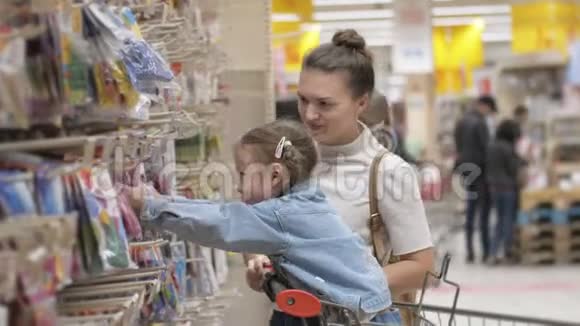 印第安纳州的肖像画年轻迷人的妈妈和小孩在超市买食物幸福家庭的侧观视频的预览图