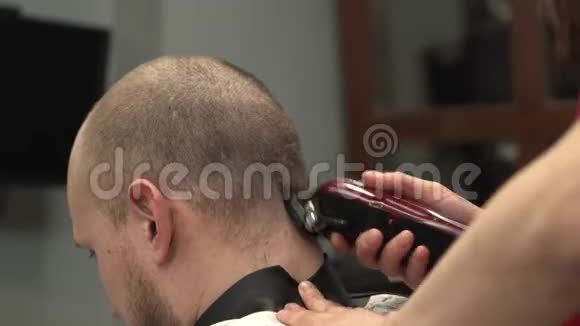 侧视女理发师理发理发师剃掉客户的头发视频的预览图