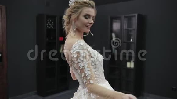 身穿白色婚纱头戴皇冠的金发新娘向前走视频的预览图