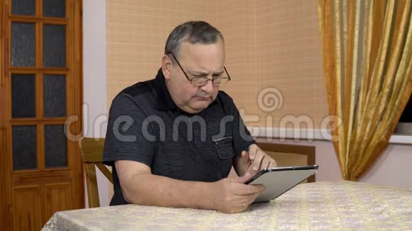 男人第一次使用平板电脑老人不明白如何使用药片戳他的手指还有视频的预览图