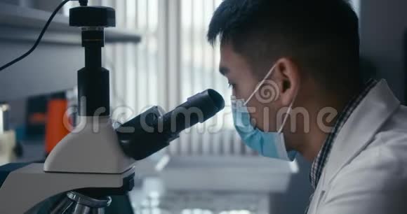 显微镜下研究样品的科学家视频的预览图