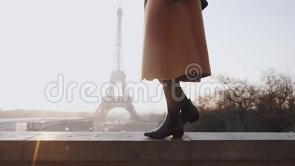 美丽的幸福女人穿着优雅的外套在浪漫的埃菲尔铁塔附近散步天空全景巴黎慢动作视频的预览图