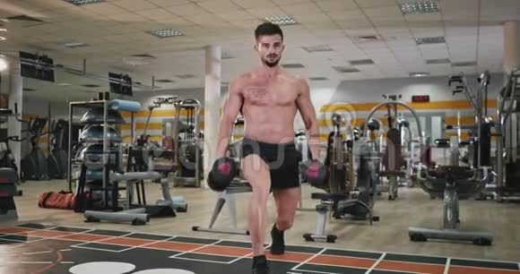 一个身材完美的身材健美的人在他工作的现代健身班里进行了艰苦的锻炼视频的预览图