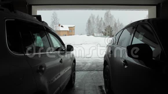 人用扔雪器擦雪从车库看到两辆车视频的预览图