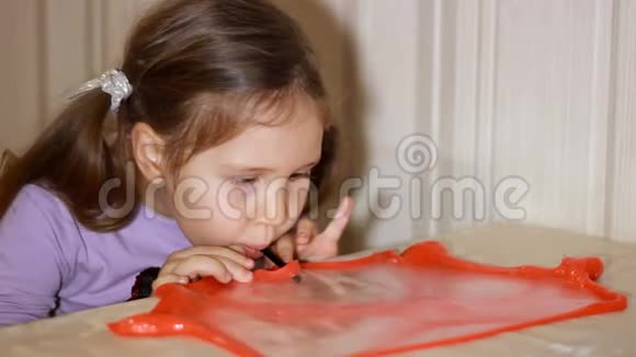 小女孩玩着做平泥孩子玩手工制作的玩具黏液放松和满足令人奇怪的是视频的预览图