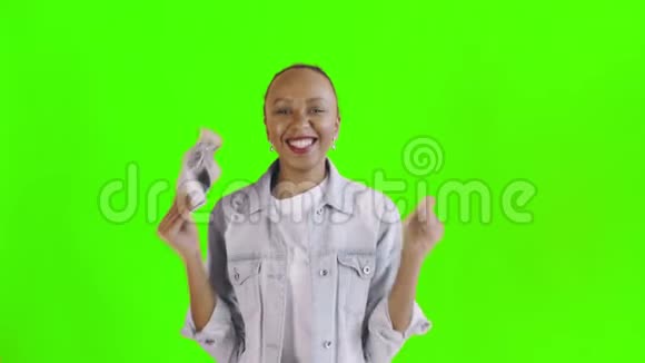 满意高兴兴奋非洲裔美国妇女展示钱和说YEAH绿色背景让夹克视频的预览图