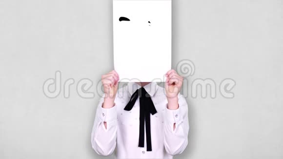 肖像少年手持白纸片用好奇的笑脸画动画遮脸情感想象视频的预览图