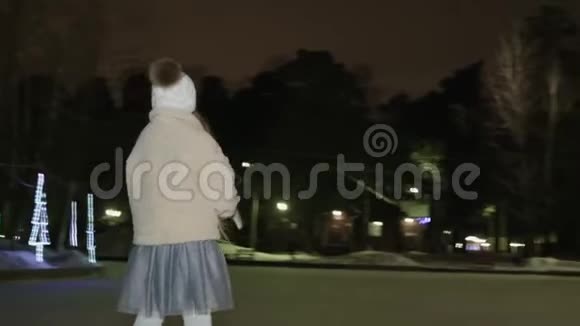 可爱的快乐少女晚上在溜冰场滑冰视频的预览图