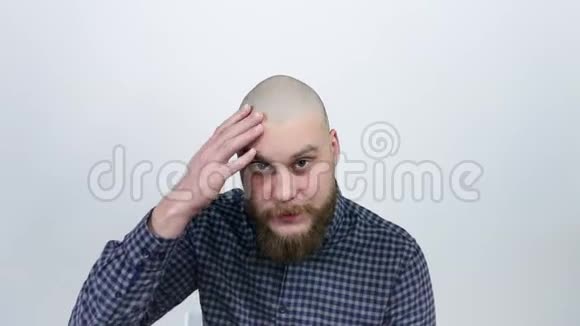 一个男人看着他秃头的倒影从脱发中体验视频的预览图