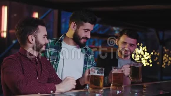 下班后一群朋友来到一家酒吧他们开始在酒吧桌上喝点啤酒享受夜晚感觉很好视频的预览图