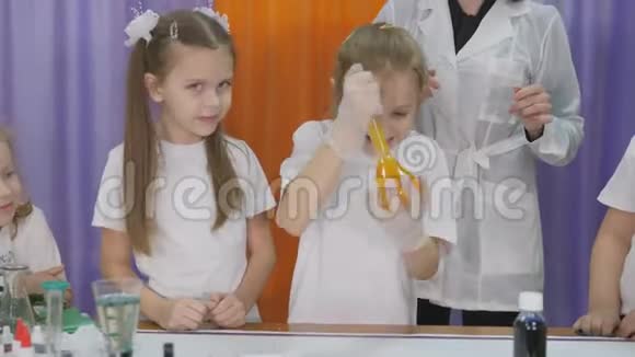 儿童化学实验幼儿摇一摇烧瓶用软木塞封闭用黄色液体房间已满视频的预览图
