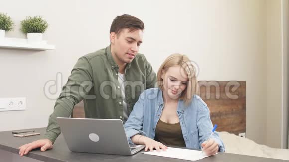 夫妻俩在家里用笔记本电脑算账视频的预览图
