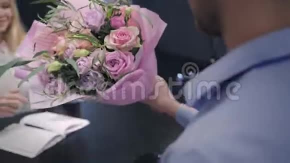 迷人的金发女郎收到一束美丽的鲜花花店照顾客户使用一个视频的预览图
