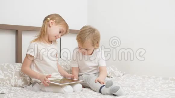 小白种人使用平板电脑坐在床上视频的预览图