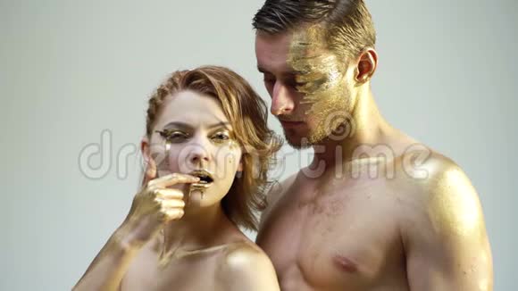 男性和女性面对周围女人头靠在男人的肩膀上全都是用金色的油漆感觉视频的预览图