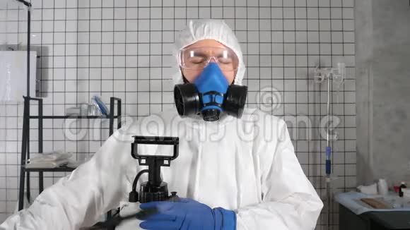 冠状病毒大流行穿防护服的医生在医院的房间里消毒视频的预览图