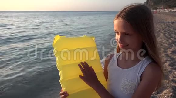 日落沙滩上玩耍的孩子看海浪的孩子岸上的女孩画像视频的预览图