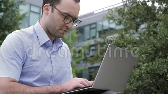 性格开朗的人在办公室外的笔记本电脑上工作视频的预览图