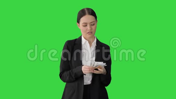 布鲁内特女士数着欧元钞票并期待着相机上的绿色屏幕铬键视频的预览图