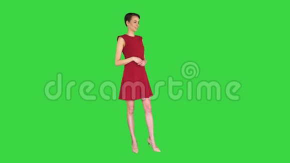 漂亮的女人穿着裙子说话和做手势就像在绿色屏幕上的天气预报色度键视频的预览图