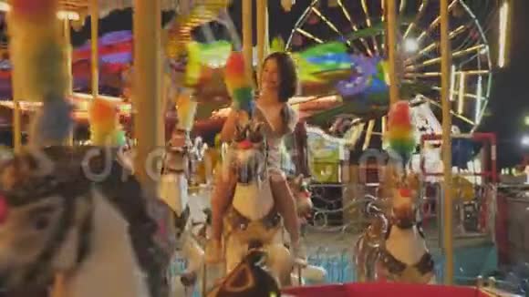 快乐的亚洲女人在游乐园骑旋转木马人和生活方式的概念放松休闲活动旅游乐趣视频的预览图